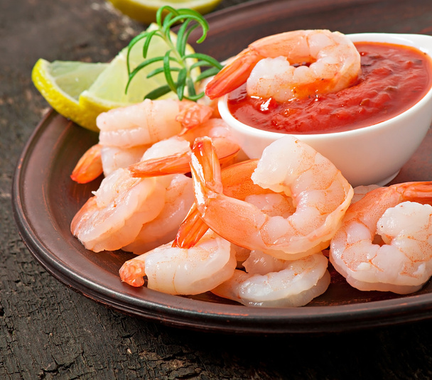 Tails of shrimps with fresh lemon and rosemary in a ceramic plate - Photo, Image