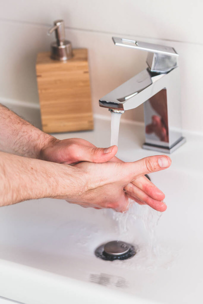 Hand washing with soap in bathroom to prevent contaminate, close up - Foto, Imagem