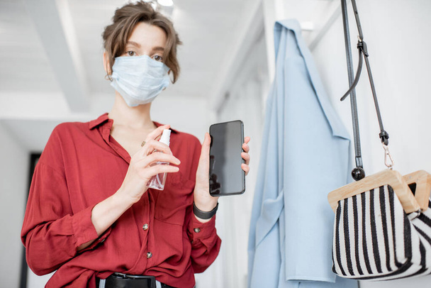 Woman disinfecting mobile phone - Foto, immagini