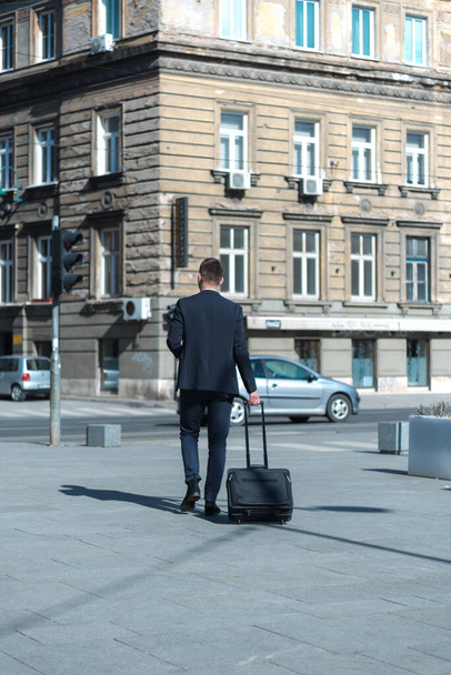 Portrait Of young Businessman  Outside Office. Meeting Concept. Man Walking and drinking coffe, going to the office. - Foto, Bild