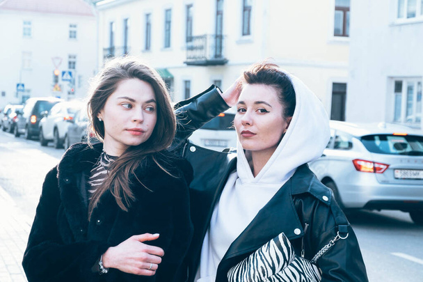 two model girls walk the streets and have fun chatting, having fun and having a good time - Fotografie, Obrázek