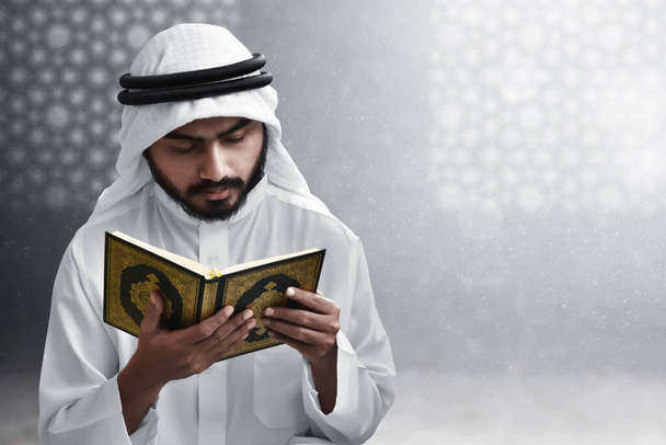 Religious arab muslim man reading holy quran - Fotó, kép