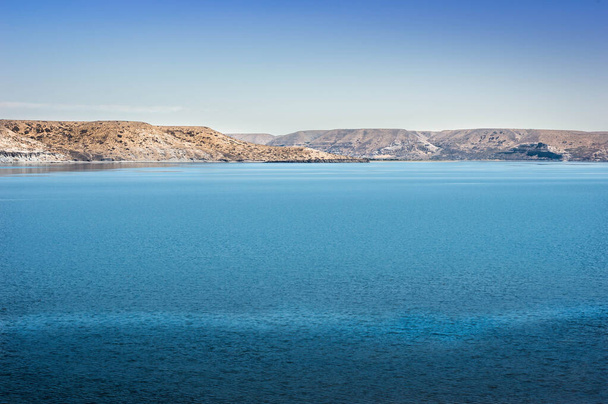 Turquoise water lagoon and mountains in the background. Neuqun, Argentina. - 写真・画像