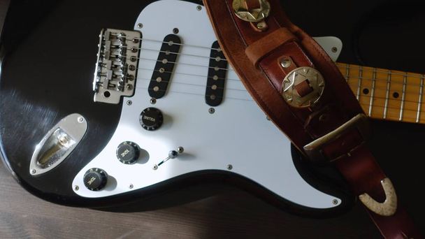 Electric guitar closeup and guitar strap .     - Foto, Imagen