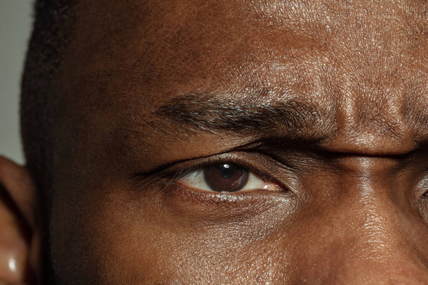 Close up of face of beautiful african-american young man, focus on eyes - Фото, зображення