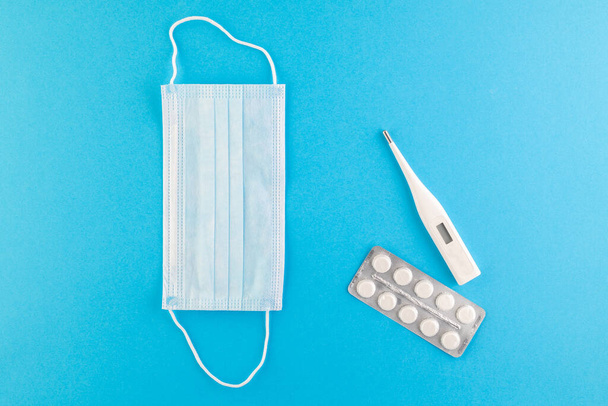 A set of hygienic antiseptics and medications on a blue background. Top view. Antibacterial protection and self-care. Stop the spread of infection. Medical hygiene and virus protection concept.  - Фото, изображение