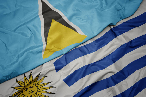 vlající barevnou vlajkou uruguaye a národní vlajkou svaté Lucie. makro - Fotografie, Obrázek