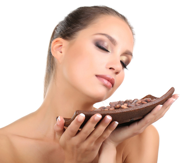 Portrait of beautiful young girl with cocoa beans isolated on white - Valokuva, kuva
