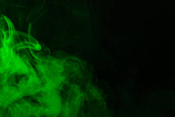 Green steam on a black background. Copy space. - 写真・画像
