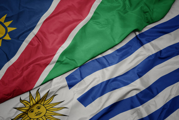 schwenken bunte uruguayische und namibische Nationalflaggen. Makro - Foto, Bild