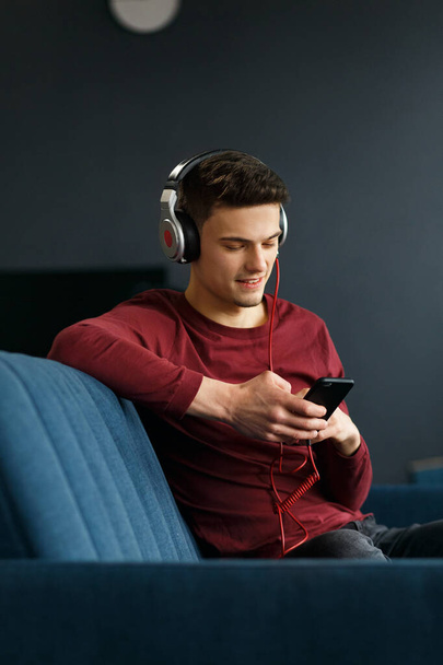 Enjoy listening to music.Young man in headphones listening music - Fotografie, Obrázek