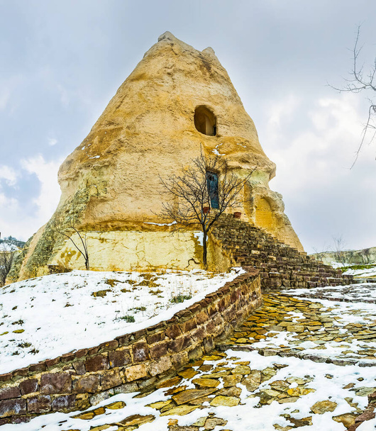 The modest facade of ancient El Nazar Kilise (Evil Eye church), cut in huge tuff rock, Goreme, Cappadocia, Turkey - Fotó, kép