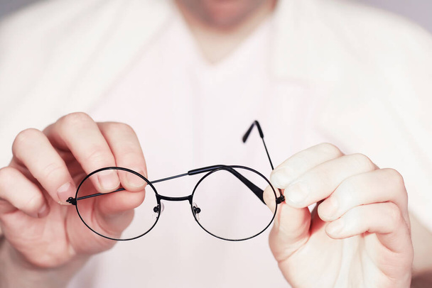Поняття поганого зору. Тримайте контактну лінзу та окуляри в руці. Афіша для реклами окулярів і лінз
. - Фото, зображення