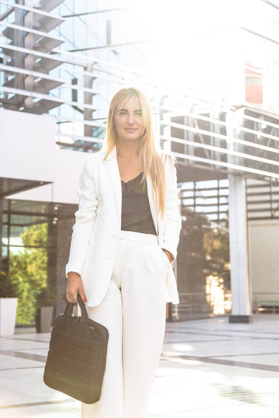 Young business woman in white suit outside - Photo, Image