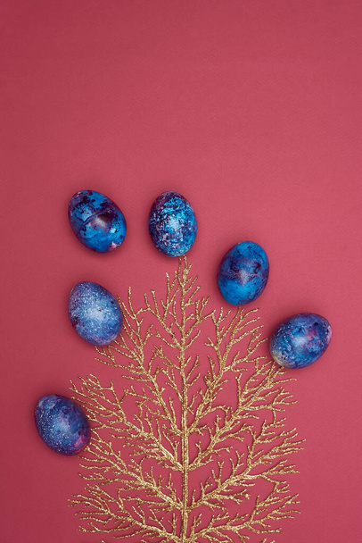           Easter festive colored eggs on black tree. Burgundy background.  - Photo, Image