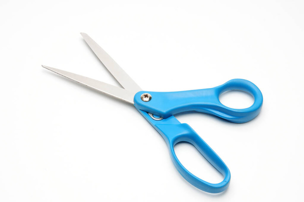 Scissors with a blue handle for tailors on an isolated white background - Fotoğraf, Görsel
