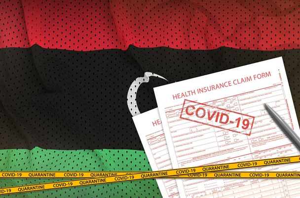 Libya flag and Health insurance claim form with covid-19 stamp. Coronavirus or pandemic 2019-nCov virus concept - Photo, Image