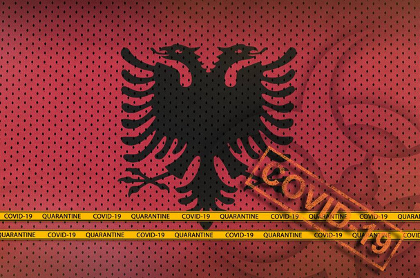 アルバニア国旗とオレンジ色のコヴィト-19スタンプ。コロナウイルスまたはパンデミック2019-nConvウイルスの概念 - 写真・画像