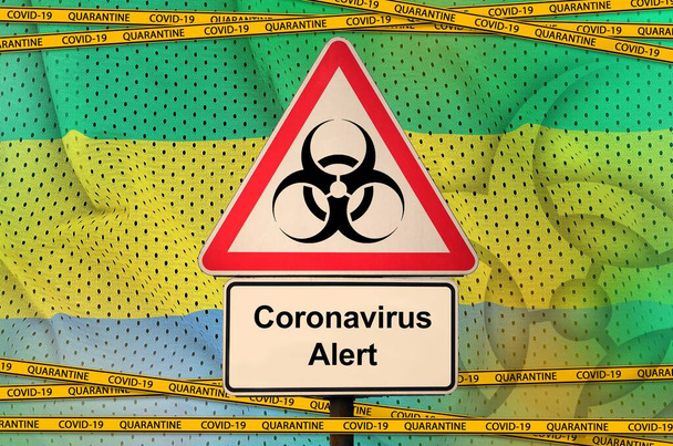 Gabon flag and Covid-19 biohazard symbol with quarantine orange tape. Coronavirus or pandemic 2019-nCov virus concept - Photo, Image