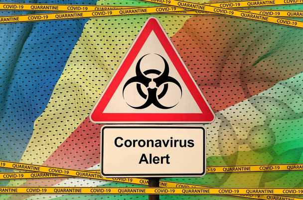 Seychelles flag and Covid-19 biohazard symbol with quarantine orange tape. Coronavirus or pandemic 2019-nCov virus concept - Photo, Image