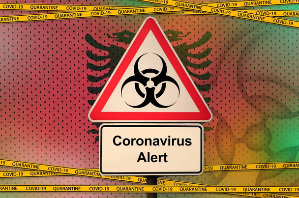 アルバニアフラグと隔離オレンジテープとCovid-19バイオハザードシンボル。コロナウイルスまたはパンデミック2019-nConvウイルスの概念 - 写真・画像