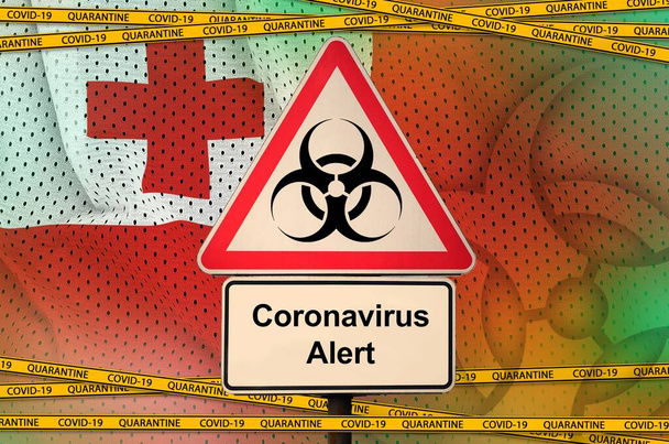 Tonga vlajka a Covid-19 biohazard symbol s karanténní oranžovou páskou. Coronavirus nebo pandemie 2019-nCov virus koncept - Fotografie, Obrázek