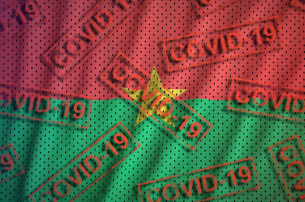 Burkina Faso zászló és sok piros Covid-19 bélyeg. Coronavirus vagy pandémia 2019-nCov vírus koncepció - Fotó, kép