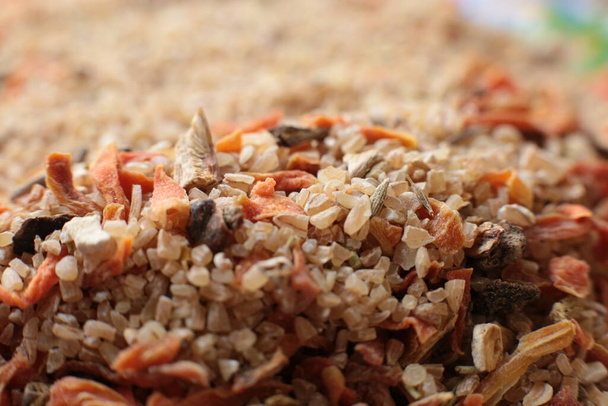 Macro photo background dry mix for spelled porridge with porcini mushrooms and dried carrots - Photo, Image