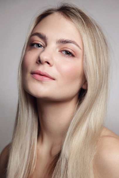 Portrait of young beautiful blonde girl with clean makeup - Foto, Imagen