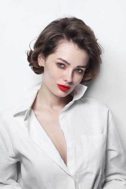 Young beautiful woman with curly hair and red lips - Fotografie, Obrázek