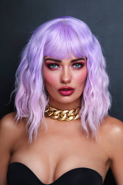 Potrait of young beautiful tanned woman with lilac hair and bright fancy makeup - Photo, Image