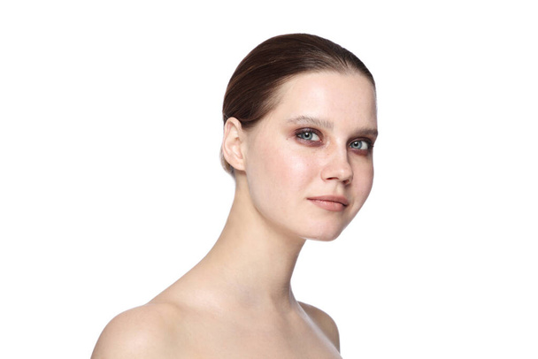 Portrait of young beautiful woman with smoky eye makeup over white background - Photo, image