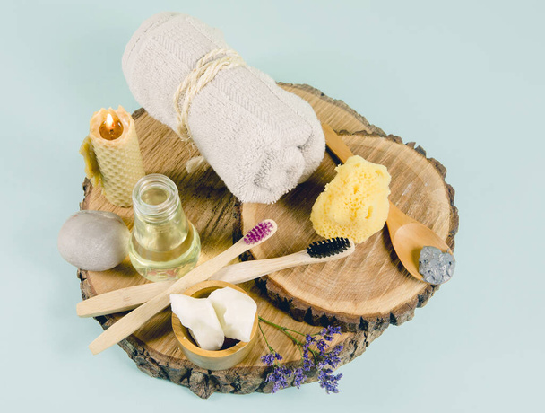 Using natural material products in home, different cosmetic products in bathroom. Minimizing ecological footprint concept. Bamboo bath towel, biodegradable bamboo toothbrush, clay mask, coconut oil. - Photo, Image