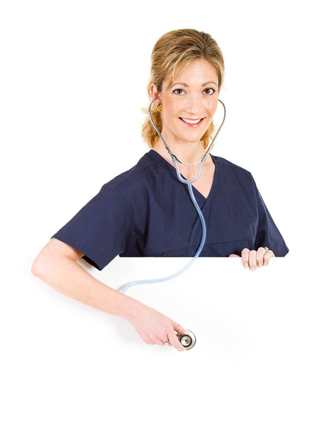 Female as physician in scrubs with stethoscope in various poses, isolated on white. - 写真・画像