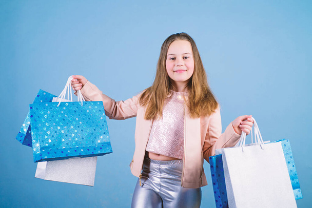 Little girl with bunch packages. Fashion girl customer. Happy child in shop with bags. Shopping day happiness. Buy clothes. Birthday girl shopping. Fashion boutique. Fashion trend. Fashion shop - Foto, Imagem