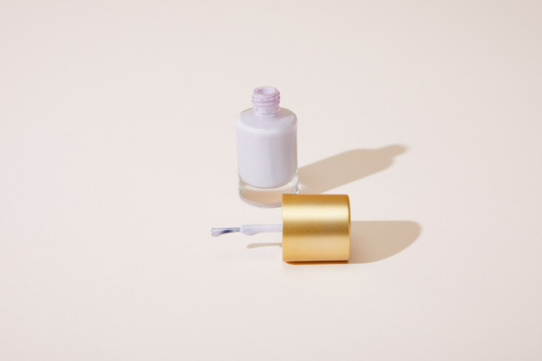 High angle view of opened bottle of nail polish on white  - Valokuva, kuva