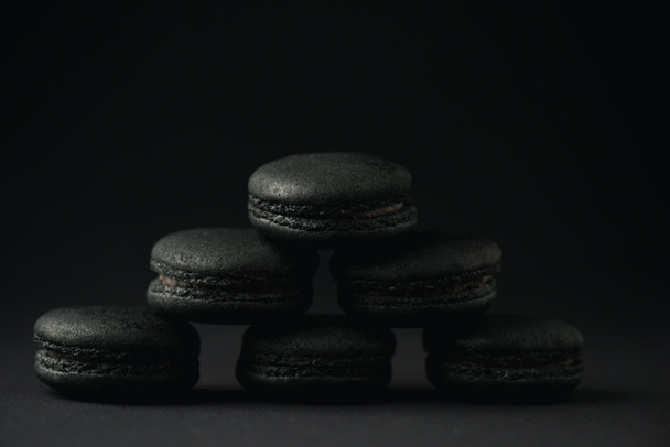 dark and delicious macarons on black with copy space  - Zdjęcie, obraz