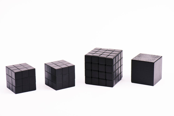 KYIV, UKRAINE - FEBRUARY 21, 2020: black rubik cubes isolated on white with copy space  - Fotografie, Obrázek