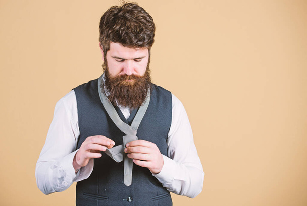 Looking classy. Elegant man. Bearded man tying a tie. Brutal caucasian man adjusting fashion accessory. Man with long beard and moustache dressing in classic style, copy space - Valokuva, kuva
