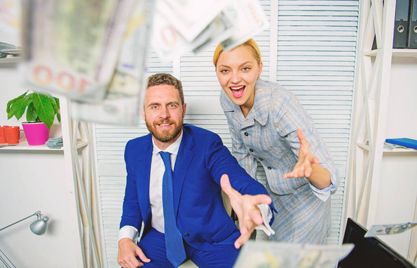 Easy profit business tips. Man and woman cheerful happy colleagues throw up dollar banknotes. Businessman hold cash dollars. Huge profit concept. Celebrate profit. Profit and richness concept - 写真・画像