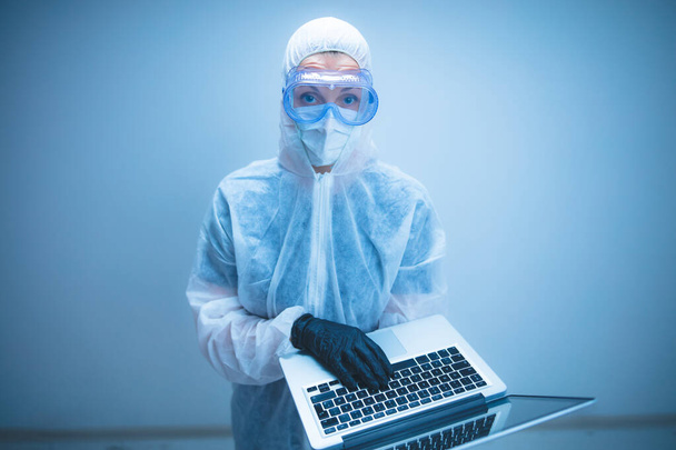 Self-isolation and working from home, prevention, hysteria, fear of viruses and diseases. Medical doctor scientist using laptop for research. - Photo, Image