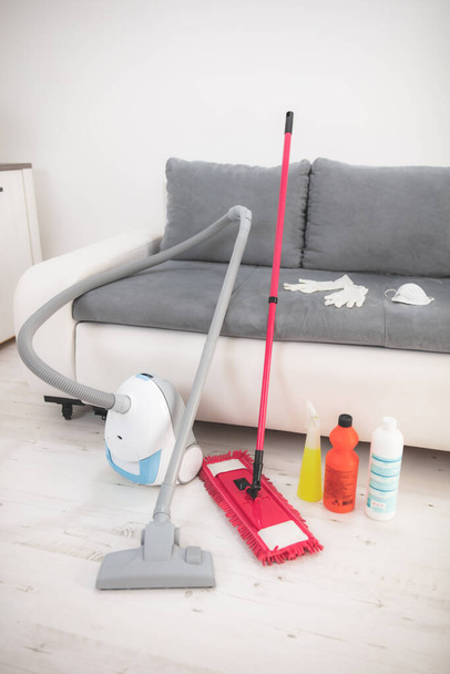 Home, apartment and room sterilization / decontamination, cleaning, vacuuming with vacuum cleaner and chemicals in the time of dangerous viruses. - Photo, Image