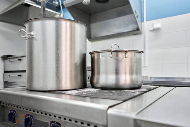 Closeup of large pots on the stove. Chef cooking at commercial kitchen - hot job. real dirty restaurant kitchen. - 写真・画像