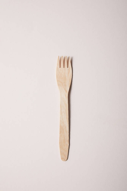 tenedor de madera aislado sobre papel beige
 - Foto, imagen