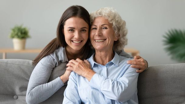 Happy elderly mom and adult daughter posing together - Photo, Image