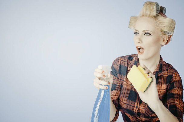 Portrat of af  a Pin up Young  Blonde girl with cleaning product isolated  - 写真・画像