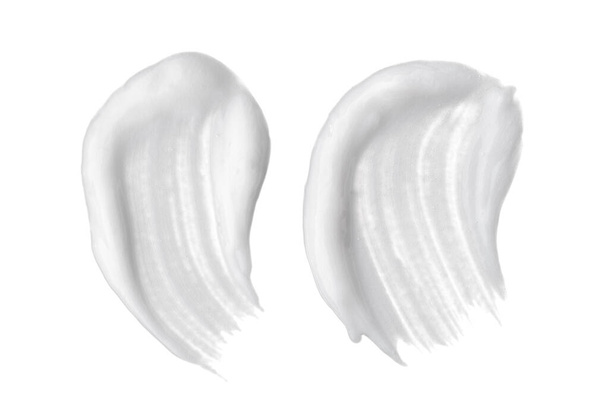 White smear of cosmetic cream or white acrylic paint isolated on white background. - Photo, Image
