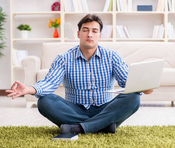 Young handsome man sitting on floor at home - Foto, imagen