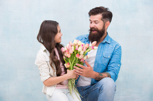womens day celebration. kid and dad prepare flowers for mothers day. spring and beauty. father and daughter with flowers. Happy family portrait. girl greeting dad with Fathers Day - Foto, Bild