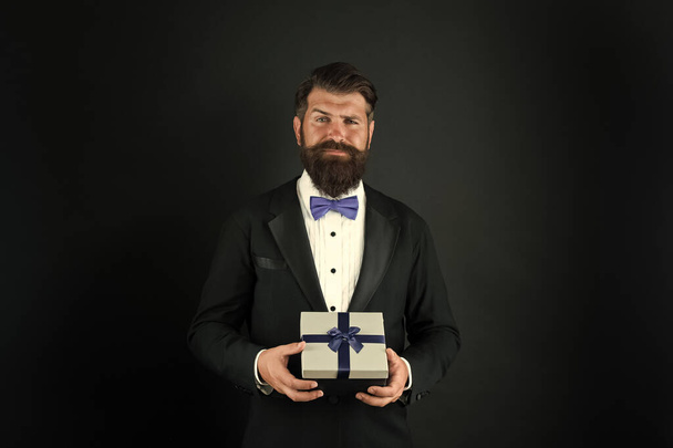 Gift whatever you want. Businessman with gift dark background. Bearded man hold gift box. Boxing day. Gift from boss. Award and benefit. Bonus and reward. Giveaway. Solution for any occasion - Fotó, kép